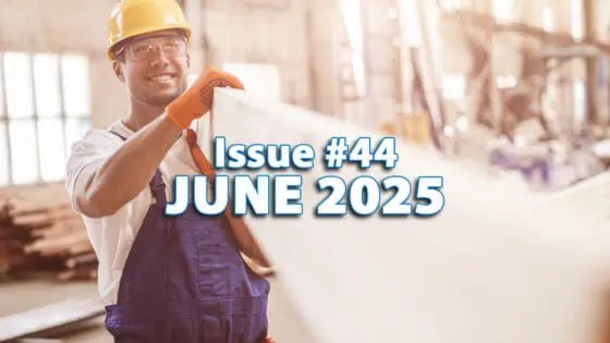 Industrial worker inspecting a large white sheet in a manufacturing facility; construction safety gear ideal for industrial environments.