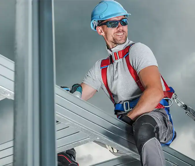 Get your contractor's license. Man in construction safety gear working on building scaffolding for commercial or residential project, emphasizing safety and professional construction services.