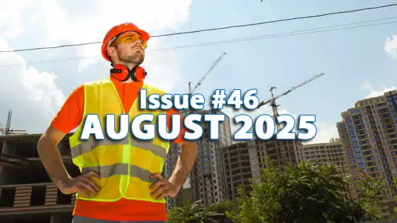 Construction worker wearing safety gear, standing confidently at a building site with cranes in the background, highlighting construction site management and safety.